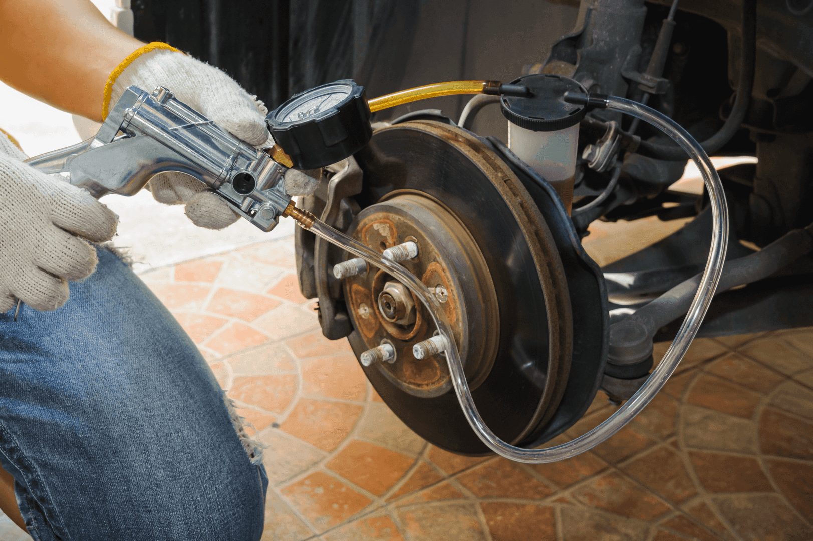 Brake fluid bleed kit in use