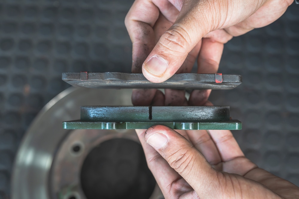 Worn brake pads with exposed metal